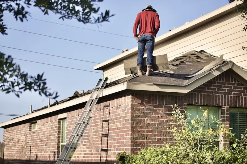Professional roofer working on a residential roof in Montowese